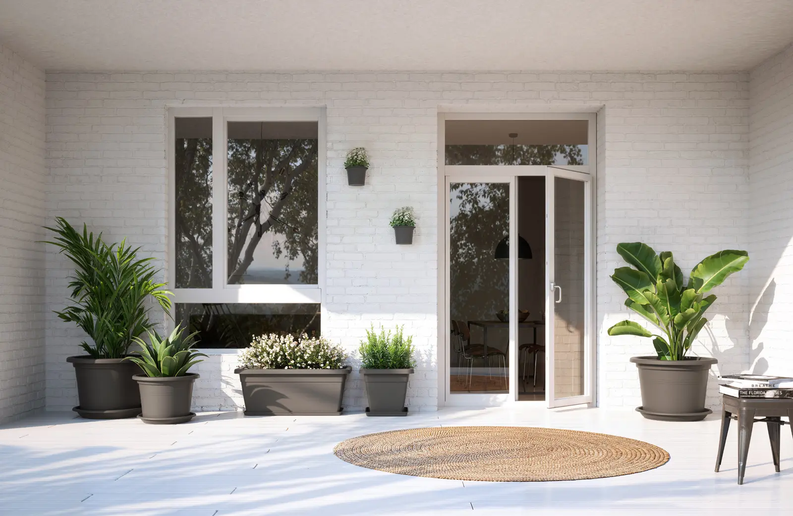 06070000544_2 Conjunto de macetas y jardineras Venezia color antracita decorando una terraza exterior soleada con plantas ornamentales.